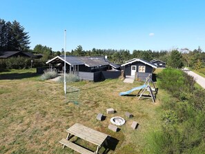 A residential area with houses, a playground, and a picnic table.
