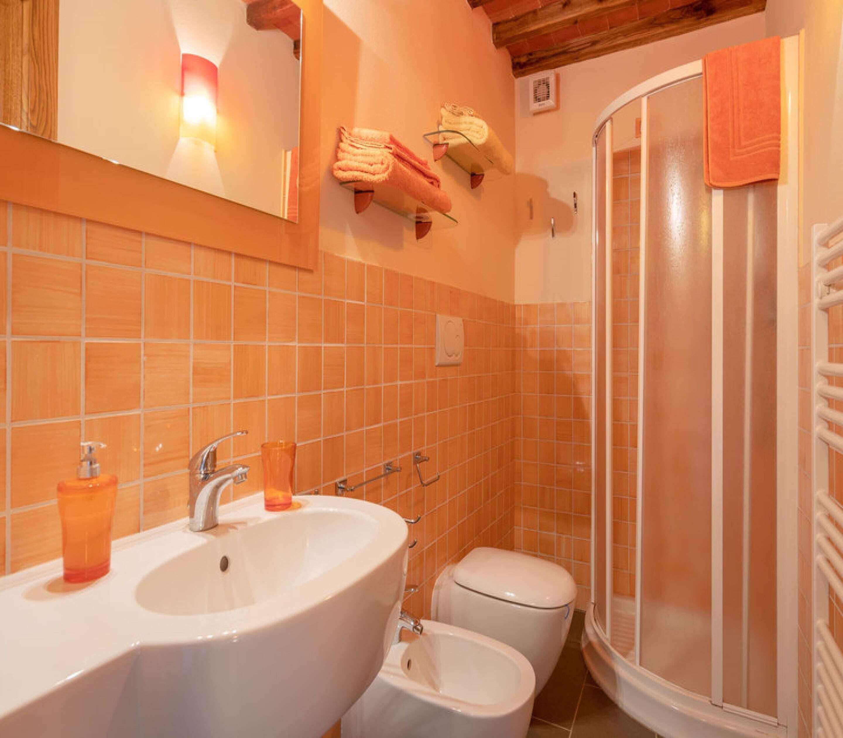 A bathroom with a sink, toilet, and shower.