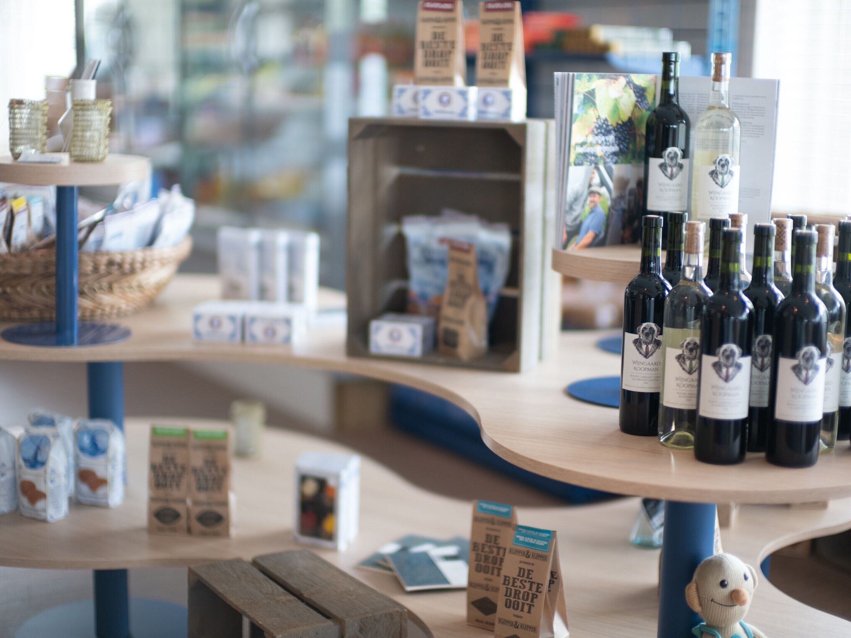 A store interior with shelves displaying wine bottles and coffee products.