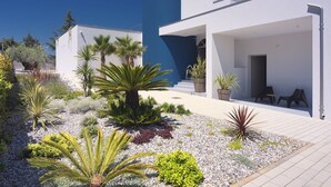 A modern house with a white exterior, a blue accent wall, and a covered patio area with outdoor seating. - Villa in Stinjan With Pool and Sea View (Pula)