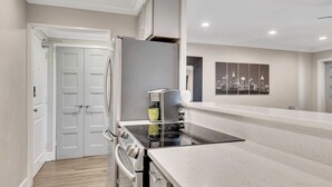 A modern kitchen with a built-in oven, a stovetop, and a coffee maker. - Downtown retreat on iconic Peachtree w/ balcony (Atlanta)