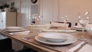A dining table set with plates, glasses, and a knife. - Cottage in Paesens Near Wadden Sea (Paesens)