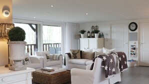 A spacious living room with a sofa set, a coffee table, and a decorative plant. - Cottage in Paesens Near Wadden Sea (Paesens)