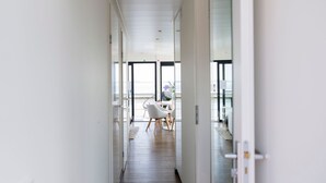 A modern, well-lit hallway with a dining area at the end, featuring a table and chairs. - Houseboat Sneekermeer With Sun Deck (Offingawier)