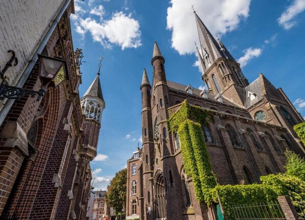 A historic church with tall spires and ivy-covered walls.