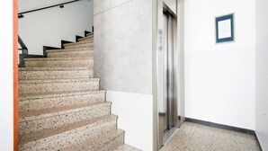 A staircase leading to an elevator in a building. - Chalet in Kaprun Near Ski Slopes (Kaprun)