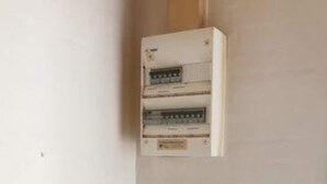 A white electrical panel with multiple switches and a label, mounted on a wall. - 6 Person Holiday Home in Karrebaeksminde (Karrebæksminde)