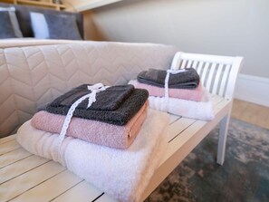 A wooden bench with folded towels in various colors and a white lace ribbon. - Holiday Home in Medemblik With Garden (Medemblik)