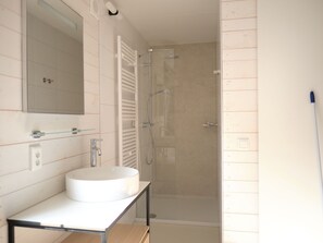 A bathroom with a white sink, a mirror, a towel rack, and a shower enclosure. - Special Lodge With Great View, Near Maastricht (Gulpen)