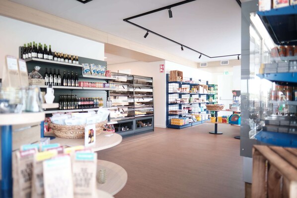 A store interior with shelves stocked with wine bottles, packaged goods, and other items. - Lodge in Callantsoog Near North Sea Beach (Callantsoog)