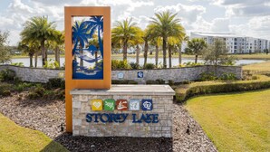 A sign with 'STORY LAKE' and icons indicating amenities like a pool, restaurant, and gym. - "Pequod Lakeview" - 4BD/3BA Townhome near Disney (Kissimmee)