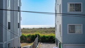A view of a building with a clear sky and a distant body of water.