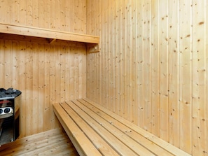 A sauna room with wooden walls and benches. - Holiday Home in Brovst (Brovst)