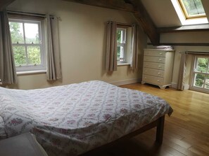 A bedroom with a bed, two windows, a dresser, and a skylight. - Lovely 3-bed House at Clashganny Mill, Borris (Clashganny)