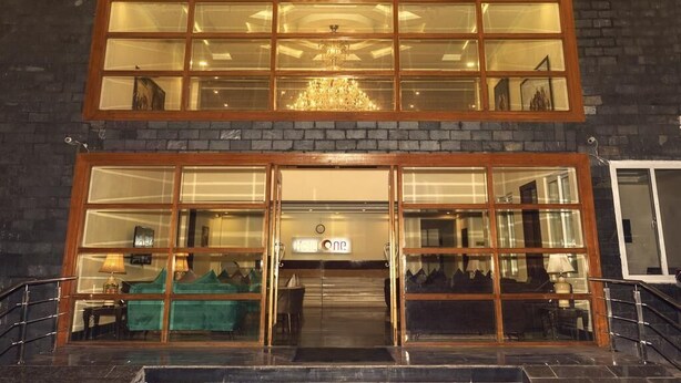 A hotel entrance with a double door, a chandelier, and a sign that reads "HOTEL ONE". - Hotel One Naran (Balakot)