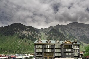A multi-story hotel with a symmetrical facade, large windows, and a central entrance.