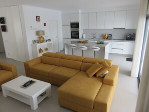 Relax in a stylish living area with a large sofa, coffee table, and kitchenette.