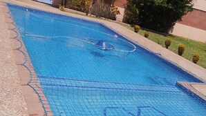A swimming pool with a tiled deck and a netted area. - Sparkle Guesthouse - Self-Catering with private pool and garden (Maputo)
