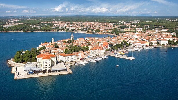 An aerial view of a coastal town with a prominent tower, marina, and dense residential buildings. - Charming Bungalow with a Terrace - Pet Friendly (Porec)