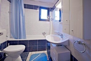 Bathtub, hair dryer, towels