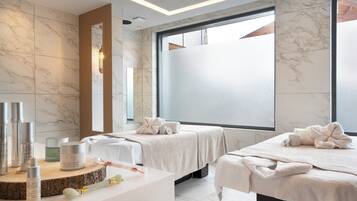 Relax in a serene spa room with two treatment beds and a minimalist design.