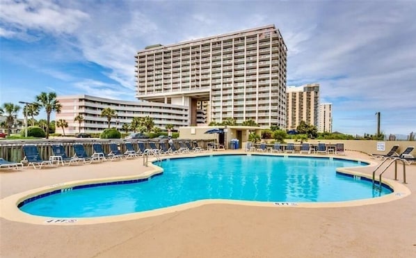 A hotel with a large swimming pool, multiple balconies, and a modern architectural design. - Amazing Oceanfront Condo @ NH Tower Kingston-Indoor Pool/Hot Tub, Outdoor Pool (Myrtle Beach)