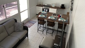 A compact kitchen with a dining area, a sofa, and a TV. - The place to go when you want to get away! (Key Largo)