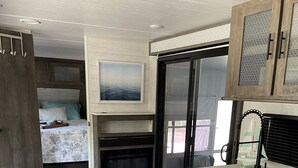 A compact, modern kitchen with a herringbone-patterned floor, built-in appliances, and a small island with a sink. - The place to go when you want to get away! (Key Largo)