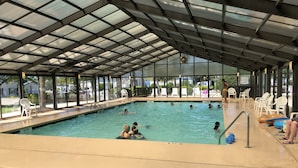 An indoor swimming pool with clear water, marked depth lines, and a covered roof. - 3 BEDROOM BEACH HOUSE WITH GOLF CART! (Myrtle Beach)