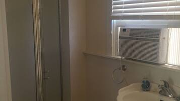 Shower, hair dryer, soap, toilet paper