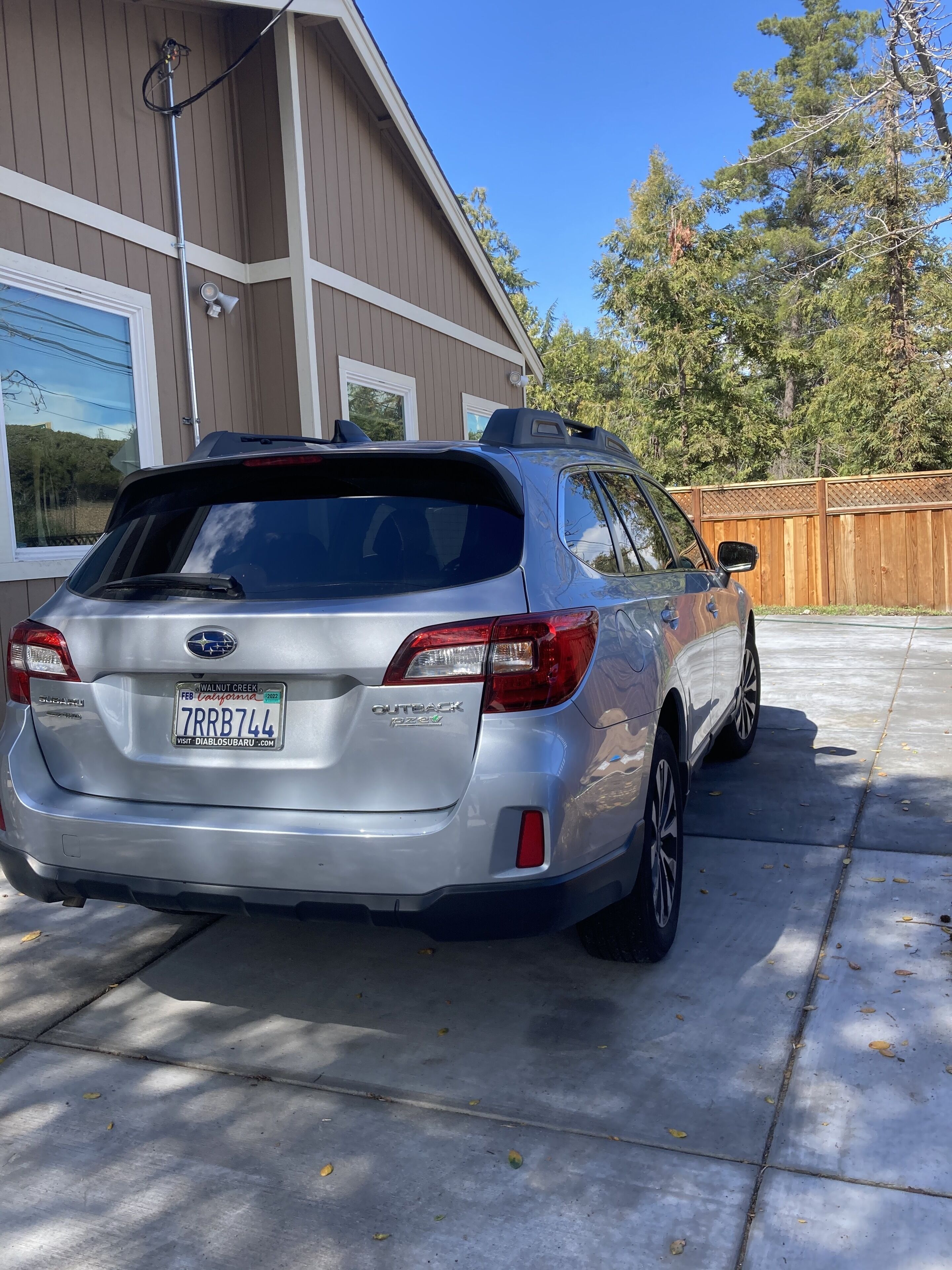 A silver Subaru Outback PZEV parked in a driveway.