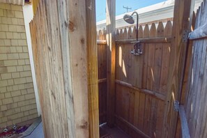 A wooden outdoor shower enclosure with a metal showerhead and a wooden fence. - 1 Min. Walk to Water/Town Deck and A/C! (Provincetown)