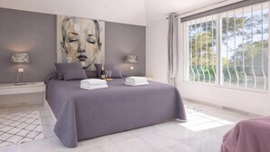 A bedroom with a large bed, a painting on the wall, and a window with a view. - Pool Villa Rancho Domingo family friendly, Benalmádena, Spain (Benalmádena)