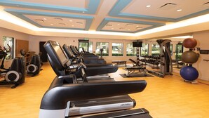 A gym with treadmills, elliptical machines, and free weights. - Beautiful updated Condo in World Class Resort Near Disney (Orlando)