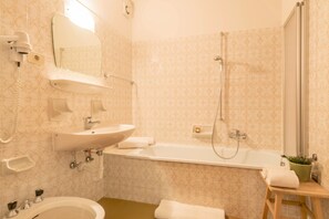 Bathtub, hair dryer, towels