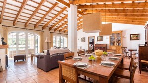 A spacious dining area with a wooden table set for a meal, surrounded by chairs. - Finca Na Bona · Finca Na Bona. Perfect location. Menorca (Mahón)