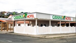 A two-story hotel named Cayapas Hotel with a white facade and a red roof.