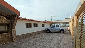 A parking area with a white pickup truck parked in the middle.