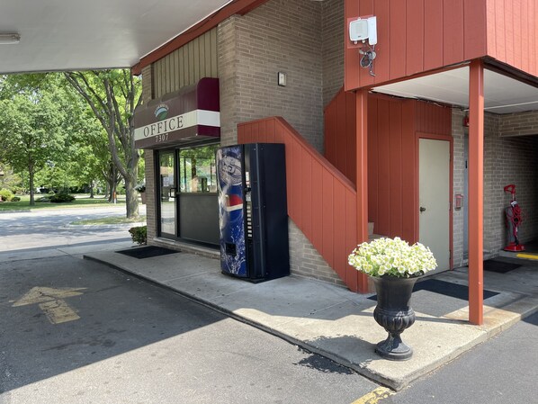 A building with a sign reading "OFFICE 7307" and a staircase leading to an entrance. - VIBE INN - WHIRLPOOL SUITES (Lyons)