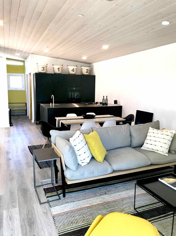 Relax in this stylish living space with a sofa, coffee table, and dining area.