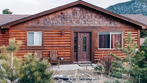 A log cabin with a symmetrical facade, a central door, and two windows on either side. - Longs Peak Lodge; An Easy walk to downtown! #3221 (Estes Park)