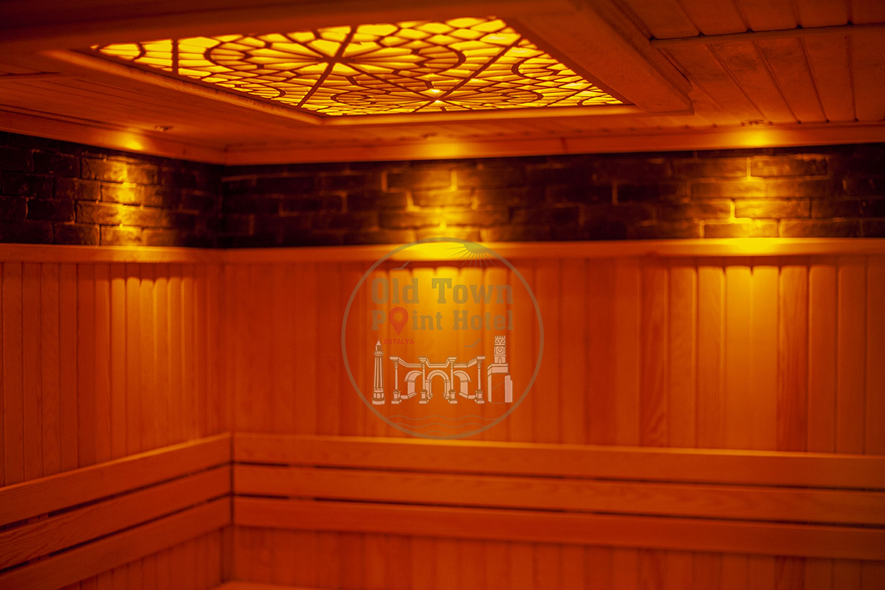A room with wooden paneling, a patterned ceiling, and a logo for Old Town Point Hotel.