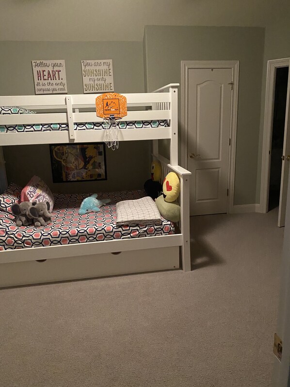 A bunk bed with a basketball hoop, plush toys, and motivational posters. - Amazing lake spot across from #12 Applerock tee box! (Horseshoe Bay)
