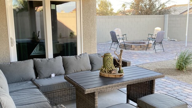 An outdoor patio area with a sectional sofa, a small table, and two chairs. - 15 minutes to strip !!! Vegas getaway (N las vegas)
