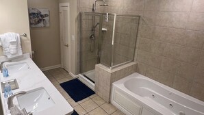 A modern bathroom with a glass-enclosed shower, a large bathtub, and two sinks. - Short walk to pools and the beach! Updated 2bdrm condo! All Hilton pool access! (Myrtle Beach)