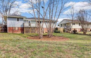 A residential property with a front yard, a wooden deck, and a detached garage. - Cardinal Gem - 3 bdrm/2bath home in Taylors (Taylors)