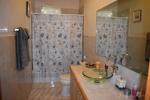 Combined shower/bathtub, towels, toilet paper