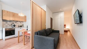 A modern apartment with a kitchen, dining area, and living room.