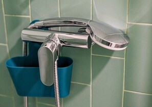 A chrome faucet with a flexible hose, mounted on a tiled wall. - GuestReady - Porto Home II (with balcony) (Porto)