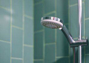 A showerhead with a circular design and a chrome finish.